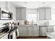 Modern kitchen featuring gray cabinets, stainless steel appliances, and granite countertops at 22610 N 17Th St, Phoenix, AZ 85024