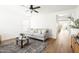 Bright living room with a ceiling fan, wood-look floors, and contemporary furnishings at 22610 N 17Th St, Phoenix, AZ 85024