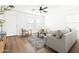 Open-concept living room showcasing hardwood floors, a ceiling fan, and inviting furniture at 22610 N 17Th St, Phoenix, AZ 85024