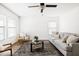 Bright living room with hardwood floors, modern ceiling fan, and neutral decor at 22610 N 17Th St, Phoenix, AZ 85024