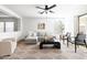 Spacious living room with a sliding glass door, a ceiling fan, and a neutral color palette at 22610 N 17Th St, Phoenix, AZ 85024