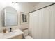 Bathroom featuring a vanity with an arched mirror, quartz countertop, and a shower with a white curtain at 22864 E Via Del Sol --, Queen Creek, AZ 85142