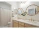 Bathroom featuring dual sinks with a wooden vanity, quartz countertop, and plenty of lighting at 22864 E Via Del Sol --, Queen Creek, AZ 85142