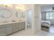 Bright bathroom featuring dual sinks with gold hardware, and views of the water closet and bedroom at 22864 E Via Del Sol --, Queen Creek, AZ 85142