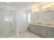 Bright bathroom featuring dual sinks, stylish lighting, a soaking tub, and a glass shower at 22864 E Via Del Sol --, Queen Creek, AZ 85142