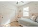 bedroom featuring paneled walls, a ceiling fan, and shuttered windows at 22864 E Via Del Sol --, Queen Creek, AZ 85142