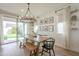 Bright dining area with a wooden table, modern chandelier, and sliding glass doors to the backyard at 22864 E Via Del Sol --, Queen Creek, AZ 85142