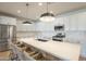 Bright kitchen featuring white cabinets, a stainless steel refrigerator, and a center island with seating at 22864 E Via Del Sol --, Queen Creek, AZ 85142