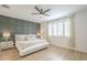 Serene bedroom with a decorative paneled wall, a comfortable bed, and light-filled windows with shutters at 22864 E Via Del Sol --, Queen Creek, AZ 85142