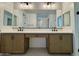 Bathroom showcasing a double vanity with framed mirrors and stylish light fixtures at 26029 N 23Rd Ave, Phoenix, AZ 85085