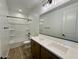 Bathroom featuring a double sink vanity, large mirror, and shower-tub combination at 26029 N 23Rd Ave, Phoenix, AZ 85085