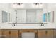 Bright bathroom featuring double sinks, modern fixtures, and a large mirror at 26029 N 23Rd Ave, Phoenix, AZ 85085