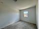 Neutral bedroom featuring a window, carpet flooring, and ample natural light at 26029 N 23Rd Ave, Phoenix, AZ 85085