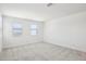 A large bedroom with neutral carpet and two windows at 26029 N 23Rd Ave, Phoenix, AZ 85085