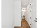 Hallway with wood-look floors leading to a powder room with pedestal sink at 26029 N 23Rd Ave, Phoenix, AZ 85085