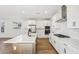 Open kitchen includes an island, stainless appliances, white cabinets and wood-look flooring at 26029 N 23Rd Ave, Phoenix, AZ 85085