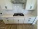 Stylish kitchen with a modern gas range, white cabinets, and subway tile backsplash at 26029 N 23Rd Ave, Phoenix, AZ 85085