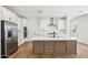 New kitchen boasts stainless steel appliances, white cabinets, quartz countertops and a kitchen island at 26029 N 23Rd Ave, Phoenix, AZ 85085