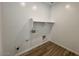 Functional laundry room with space for appliances and overhead shelving at 26029 N 23Rd Ave, Phoenix, AZ 85085