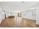 Spacious open-concept living area with wood floors leading to a modern kitchen and outdoor access at 26029 N 23Rd Ave, Phoenix, AZ 85085