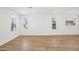 Light-filled living room features wood flooring and multiple windows at 26029 N 23Rd Ave, Phoenix, AZ 85085
