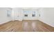 Open-concept living room boasts wood flooring and natural light from the windows at 26029 N 23Rd Ave, Phoenix, AZ 85085