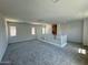Bright loft area with a white railing, multiple windows, and neutral carpeting at 26029 N 23Rd Ave, Phoenix, AZ 85085