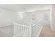 Spacious loft area with neutral carpet and a white railing at 26029 N 23Rd Ave, Phoenix, AZ 85085