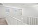 Bright loft space with carpet, white railings, and several windows providing plenty of natural light at 26029 N 23Rd Ave, Phoenix, AZ 85085