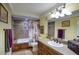 Bathroom featuring a single sink vanity, tiled bathtub and shower, with vintage accents and decor at 2637 E Beekman Pl, Phoenix, AZ 85016