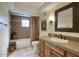 Well-lit bathroom with a wooden vanity, tiled countertop, shower, and decorative vases at 2637 E Beekman Pl, Phoenix, AZ 85016