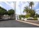 Gated community entrance with mature trees, landscaping, and the community name at 2637 E Beekman Pl, Phoenix, AZ 85016