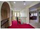 Upstairs hallway with arched accents, rod iron railing, leading to living room and staircase at 2637 E Beekman Pl, Phoenix, AZ 85016