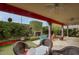 Cozy covered patio featuring a fireplace, rattan chairs, and lush greenery at 2637 E Beekman Pl, Phoenix, AZ 85016