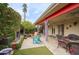 Relaxing outdoor patio area with a fireplace, cozy seating, and lush landscaping at 2637 E Beekman Pl, Phoenix, AZ 85016