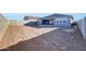 View of the empty dirt lot backyard and the house with sliding glass doors and a brick fence at 28958 N 174Th Ln, Surprise, AZ 85387