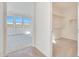 Hallway featuring wood-look tile flooring leading to a bedroom and open walk-in closet at 28958 N 174Th Ln, Surprise, AZ 85387