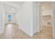 Hallway with wood-look tile flooring leading to laundry room and back patio at 28958 N 174Th Ln, Surprise, AZ 85387