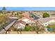 Aerial shot showcasing a home with a terracotta roof, lush landscaping, and community neighborhood at 3037 S Coyote Cyn, Mesa, AZ 85212