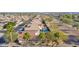 Aerial view of the community featuring tile roofs, swimming pools and desert landscaping at 3037 S Coyote Cyn, Mesa, AZ 85212