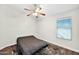 Simple bedroom with a window with blinds and ceiling fan at 3037 S Coyote Cyn, Mesa, AZ 85212