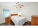 Cozy bedroom with a ceiling fan, window with blinds, and wood furnishings at 3037 S Coyote Cyn, Mesa, AZ 85212