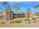 A beautiful Mesquite Canyon neighborhood entrance with stone accents and desert landscaping at 3037 S Coyote Cyn, Mesa, AZ 85212