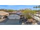 Spacious three-car garage home with manicured front yard landscaping and mature shade tree at 3037 S Coyote Cyn, Mesa, AZ 85212