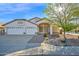 Charming single-story home featuring a well-manicured desert landscape and a spacious three-car garage at 3037 S Coyote Cyn, Mesa, AZ 85212