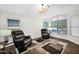 Comfortable living room featuring neutral walls, hardwood floors, and a cozy seating area with large windows at 3037 S Coyote Cyn, Mesa, AZ 85212