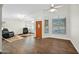 Bright living room with hardwood floors, ceiling fan, and large windows offering ample natural light at 3037 S Coyote Cyn, Mesa, AZ 85212