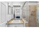 Bathroom featuring a tiled shower, a vanity with a stone countertop, and a mirror reflecting the bedroom at 3038 E Marlette Ave, Phoenix, AZ 85016