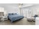 Bedroom with plantation shutters, ceiling fan, and plush chair with ottoman and side table with lighting at 3038 E Marlette Ave, Phoenix, AZ 85016