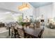 Open-concept dining room featuring a stylish chandelier and views into the living room at 3038 E Marlette Ave, Phoenix, AZ 85016